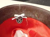a close up of a red hat with a white bow on it