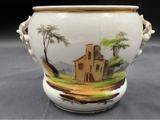 a white vase with a picture of a church on it