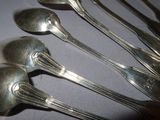 five spoons that are sitting on a table