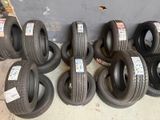several tires are lined up in a pile on the floor