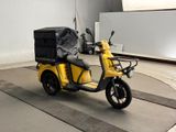 a yellow scooter with a box on the back of it