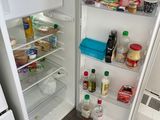 an open refrigerator with a lot of food inside of it