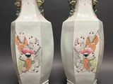 two vases that have been painted with animals on them