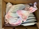 a box full of plates and a towel in it