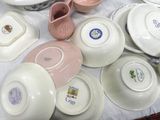a lot of plates and bowls on the table