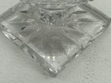 a glass bowl on a glass stand on a table