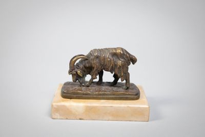 bronze statue of a goat on a marble base