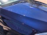 a car that has been painted blue with a sticker on it