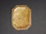 an antique gold plate with a picture of a man on it