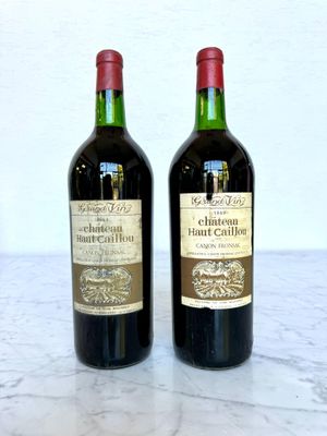 two bottles of wine sitting on a marble table