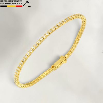 a gold bracelet with diamonds on a white background