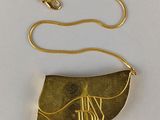 a gold plated necklace with a gold chain and a gold pendant with the word