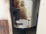 a rusted metal cabinet in the corner of a bathroom