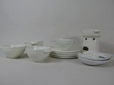 a lot of white dishes and bowls on the table