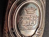 a close up of a metal object with a crown on it