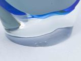 a close up of a glass vase with a blue and white design