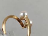 a close up of a gold ring with a pearl in it