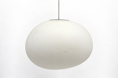 an image of a white light hanging from a ceiling