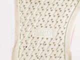 the bottom of a pair of white sneakers with pink soles