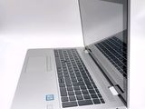 a laptop computer that is open on a white surface
