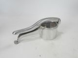 an image of a small metal cup with a handle on a white surface