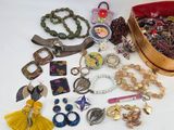 a lot of jewelry sitting on a table together