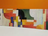 a painting on the wall of a room with orange walls