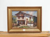 a picture of a painting of a house on a shelf