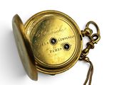 a gold pocket watch with a chain hanging from it