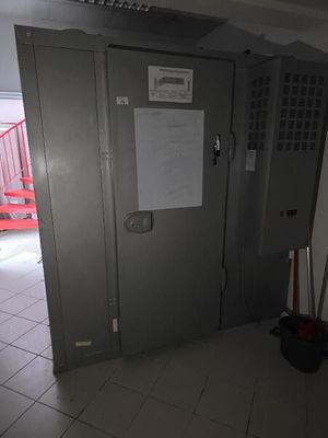 a metal locker with a sign on it in a room