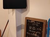 a blackboard on the wall above a broom and a chalk board