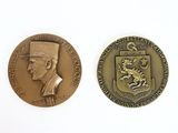 two medals with a man in a top hat and a dragon on them