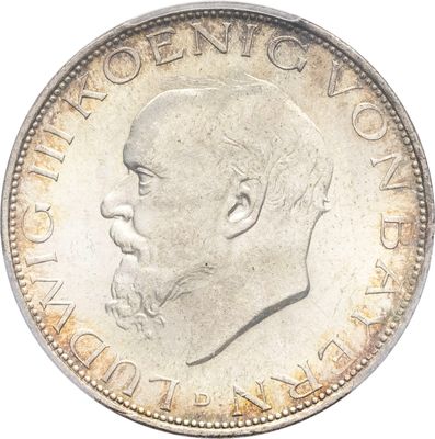 Gros plan sur une pièce de monnaie portant le visage d'un homme