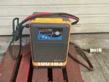 an orange and black radio sitting on top of a wooden pallet