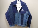 a close up of a blue jean jacket hanging on a wall