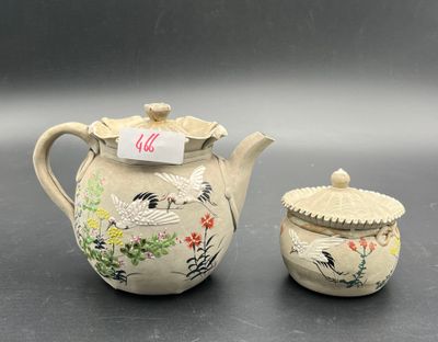 a small tea pot and a small tea pot on a table