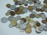 a pile of coins sitting on a white surface