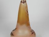 a small glass vase with a bird design on it