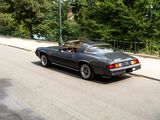 a black sports car driving down the street