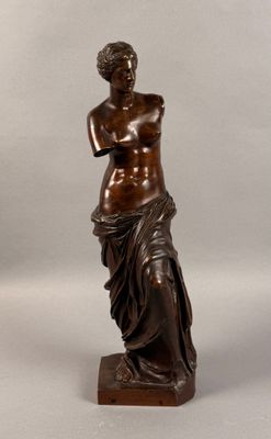 bronze statue of a woman holding a flower in her hand