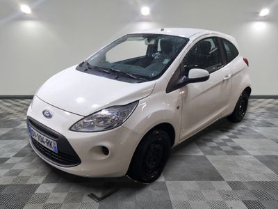 a picture of a small white car parked in a garage