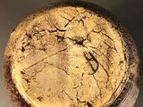 a close up of a baseball that has a crack in it
