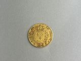 a gold coin with a coat of arms on it
