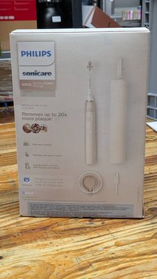 packaging of a philips soniccare electric toothbrush sitting on a wooden table