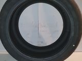 a close up of a tire on a table with a white background