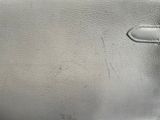 someone is holding a silver purse with a handle on a table