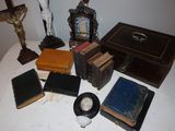 a lot of books on a table next to a crucifix