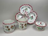 several different types of porcelain dishes and cups on a white surface