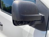 a side view mirror of a white car with a black handle