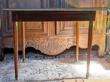 a wooden table with a glass top in a room